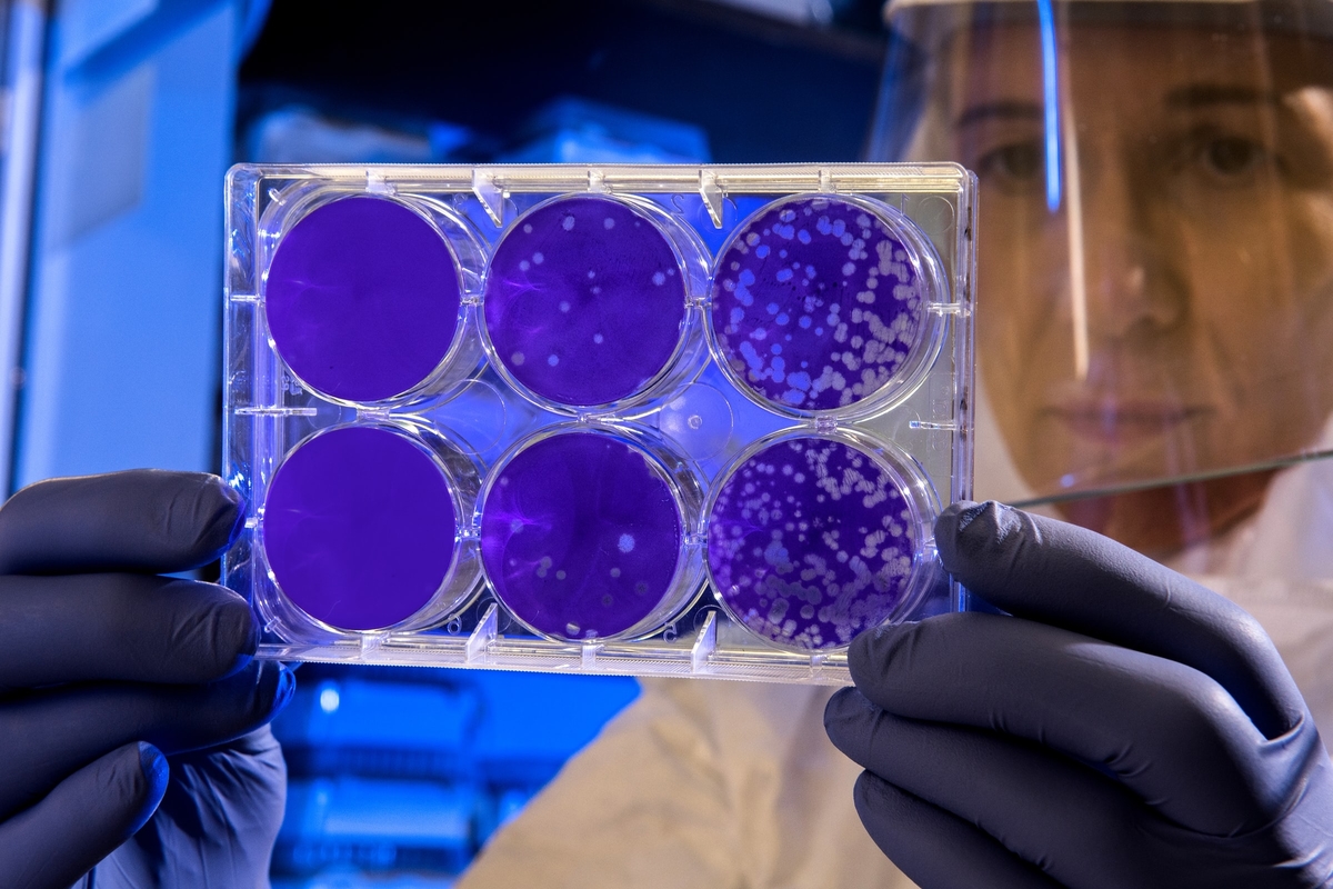 A woman holding laboratory apparatus